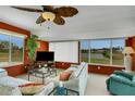 Sunroom with canal views and comfortable seating area at 1255 Lincoln Dr, Englewood, FL 34224