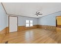 Simple living room with wood-look floors and ceiling fan at 1508 45Th E Ave, Ellenton, FL 34222