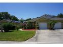 Front view of a house with a two-car garage and solar panels at 203 28Th W St, Palmetto, FL 34221