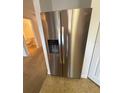 Stainless steel refrigerator with water dispenser provides convenience and style at 14812 Skip Jack Loop, Lakewood Ranch, FL 34202