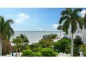 Relaxing pool area with lush tropical landscaping and scenic water views at 360 Gulf Of Mexico Dr # 322, Longboat Key, FL 34228