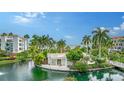 Stunning view of the water from a waterfront property with tropical landscaping at 360 Gulf Of Mexico Dr # 322, Longboat Key, FL 34228