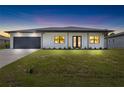 Modern house exterior with a two car garage at 4549 Targee Ave, North Port, FL 34287