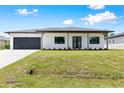 Modern house exterior with a two car garage at 4549 Targee Ave, North Port, FL 34287