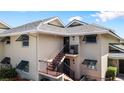 Tan building exterior with stairs and shutters at 4660 Ocean Blvd # Q2, Sarasota, FL 34242