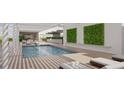 Rooftop pool with lounge chairs, pergola, and green wall at 1305 4Th St # 502D, Sarasota, FL 34236