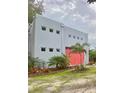 Modern home with gray siding and pink garage door at 5023 Inverness Dr, Sarasota, FL 34243