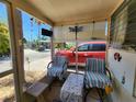 Relaxing screened porch with seating and outdoor accents at 10315 Cortez W Rd # 55-2, Bradenton, FL 34210