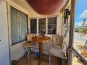 Small screened porch with table and chairs for relaxing at 10315 Cortez W Rd # 55-2, Bradenton, FL 34210