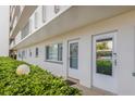 Condo building exterior hallway with lush green landscaping at 4440 Ironwood Cir # 108D, Bradenton, FL 34209