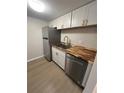 Updated kitchen with stainless steel appliances and wood countertops at 2611 Pine Lake Ter # B, Sarasota, FL 34237