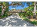 Tan house with a two-car garage and lush landscaping at 4560 Forest Wood Trl # 16, Sarasota, FL 34241