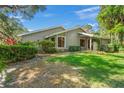 Front view of a charming house with green lawn at 4560 Forest Wood Trl # 16, Sarasota, FL 34241
