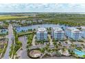Aerial view of waterfront community with lake and parking at 379 Aruba Cir # 202, Bradenton, FL 34209