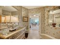 Elegant entryway with decorative wallpaper, mirrored walls, and a tasteful console table at 409 N Point Rd # 501, Osprey, FL 34229