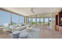 Spacious living room with large windows, comfortable seating, and stunning views at 409 N Point Rd # 501, Osprey, FL 34229