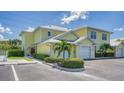 View of a yellow two-story building with attached garages at 16450 Gloria Ln # 105, Nokomis, FL 34275