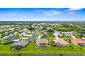 Expansive aerial view of a residential neighborhood showcasing waterfront properties and scenic surroundings at 310 Lake Tahoe Ct, Englewood, FL 34223
