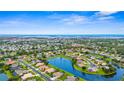 Stunning aerial view showcases a peaceful community with serene lake views and lush green landscapes at 310 Lake Tahoe Ct, Englewood, FL 34223