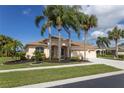 Beautiful single-Gathering home boasts a well-manicured lawn with lush landscaping in a tropical setting at 310 Lake Tahoe Ct, Englewood, FL 34223