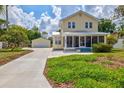 Yellow house with screened porch and a long driveway at 1810 28Th W St, Bradenton, FL 34205