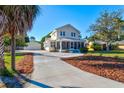 Front view of a two-story house with a long driveway and landscaping at 1810 28Th W St, Bradenton, FL 34205