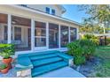 Screened porch with tiled floor, wicker furniture, and wood ceiling at 1810 28Th W St, Bradenton, FL 34205
