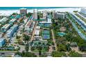 Aerial view showing resort amenities including tennis courts and pool at 5920 Midnight Pass Rd # 104, Sarasota, FL 34242