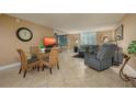 Bright living room with tile floors, comfy seating, and a glass dining table at 5920 Midnight Pass Rd # 104, Sarasota, FL 34242