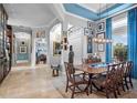 Elegant dining room featuring a large wooden table and blue accents at 5309 Greenbrook Dr, Sarasota, FL 34238