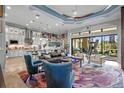 Spacious living room with open floor plan, leather sofas, and a large window offering scenic views at 5309 Greenbrook Dr, Sarasota, FL 34238