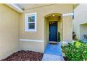Inviting entryway with a blue door and landscaping at 3902 Willow Hammock Dr, Palmetto, FL 34221