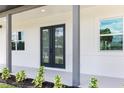 Modern front door with glass panels at 4593 Targee Ave, North Port, FL 34287