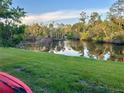 Scenic water view with lush landscaping and tranquil canal reflecting the beautiful blue sky at 3637 Mineola Dr, Sarasota, FL 34239