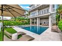 Luxury pool with lounge chairs and a modern design at 2510 Gulf N Dr, Bradenton Beach, FL 34217
