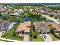 Aerial view of a luxury home community with lake and houses at 12014 Perennial Pl, Lakewood Ranch, FL 34211