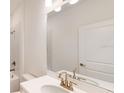 Bathroom with white vanity and gold fixtures at 16132 Ivy Ridge Ct, Port Charlotte, FL 33953