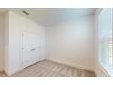 Bright bedroom with double door closet and neutral carpeting at 16132 Ivy Ridge Ct, Port Charlotte, FL 33953