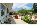 Inviting front porch with striped chairs and lush landscaping at 3005 39Th W Ave, Bradenton, FL 34205