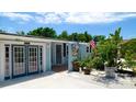Home's exterior showcasing double doors, landscaping, and a fountain next to the entrance at 3005 39Th W Ave, Bradenton, FL 34205