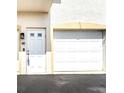 White garage door and entrance to a condo unit at 235 Base E Ave # 207, Venice, FL 34285