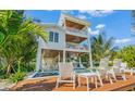 Elevated pool and deck area with lounge chairs, offering relaxing outdoor space at 404 North Shore Dr, Anna Maria, FL 34216
