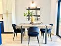Dining area with a modern table and four black velvet chairs at 5408 Swift Rd # 28, Sarasota, FL 34231