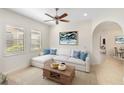 Cozy living room with light walls, comfortable sectional sofa, and wooden coffee table at 10401 Crooked Creek Dr, Venice, FL 34293