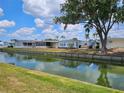 Scenic view of waterfront homes in a tranquil community, with lush greenery and serene water reflections at 407 White Oak Way, Sarasota, FL 34237
