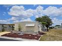 Cozy home exterior with a landscaped yard, manicured flower beds, and a well-maintained facade at 407 White Oak Way, Sarasota, FL 34237