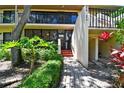 Condo building entrance with brick walkway, lush landscaping at 3438 Wood Owl Cir # 275, Bradenton, FL 34210