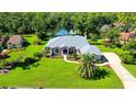 Picturesque aerial shot of a home with a large yard, pool and a serene pond at 7430 Weeping Willow Dr, Sarasota, FL 34241