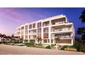 Luxury beachfront building with ocean views at sunset at 70 Avenida Veneccia # 401, Sarasota, FL 34242