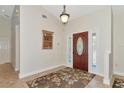 Bright and airy entryway with tile floors and elegant door at 15440 County Road 675, Parrish, FL 34219